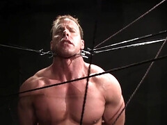 Muscular DILF stands restrained and ready for his punishment
