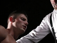 Suited men are dominating a teen with a great torso