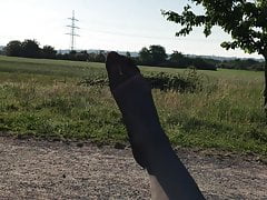 Crossdresser out in the fields posing in cheap black nylons