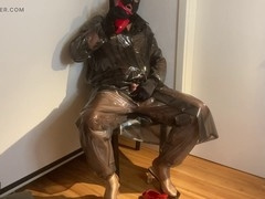 Crossdresser in red mules indulges in plastic fetish attire while getting jizzed on