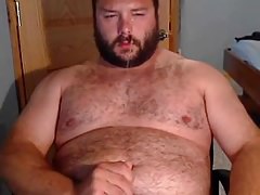 A hairy gay shoot his load on his bearded face