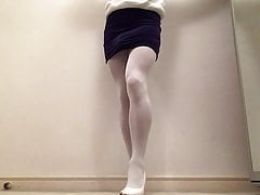 White hosed legs in blue dress .