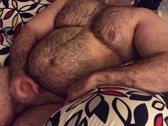 Hairy man lounging on the couch