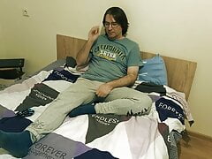 Guy is jerking on the bed and cums on his T-shirt