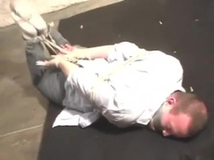 BG Frankie hogtied tape gagged and struggling.
