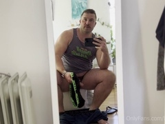 Muscular hairy hunk Koby Falks strokes his massive foreskin-covered dick and cums on a set of briefs