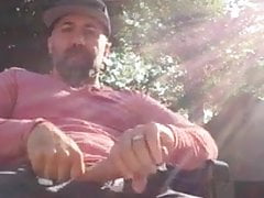 Jerks off in the garden