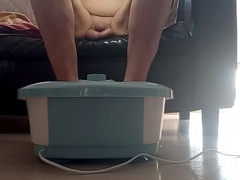 bare and soles in bubbling bathtub