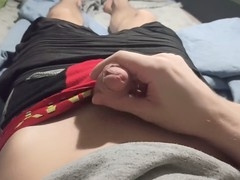 Guy in shorts jerks off his huge dick and cums while chilling at the computer