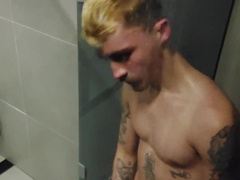 young fellow demonstrating off in the gym bathroom