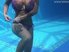 Busty Canadian pornstar Heidi Van Horny shows off her kinky side, playing and teasing underwater