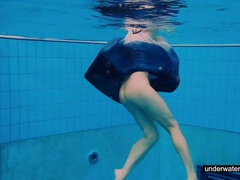 Teen girl Avenna is swimming in the pool