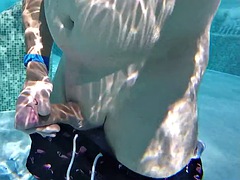 Gay guy cheekily jerks off his fat cock in a public thermal pool. Hot underwater fun