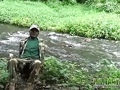Brown soldier strips naked by the stream