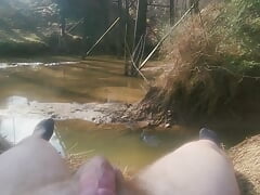 Solo down by the river next to the road