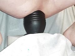 Riding on huge dildo.