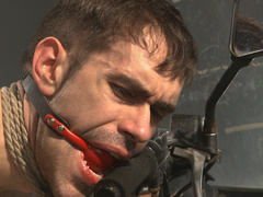 Gagged man sits restrained in roped and endures anal in merciless positions