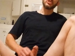 Hunky guy strokes his throbbing member while sitting on the floor