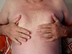 Mature chubby man plays with his big nipples and clamps them tight