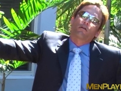 Businessman in a classy suit gets blowjob from gay buff dude