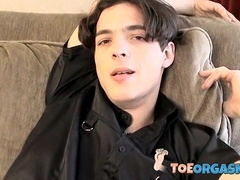 Skinny twink massages his feet and strokes massive dick