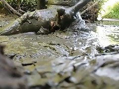 NUDE MAN PLAYING IN MUD HOLE