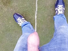 Boy takes a piss at the golf course