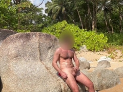 Draining off on the beach in thailand and nutting in the water. Public masturbate off