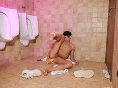 Naked twink Jimeno jerks off in the public restroom