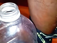 Pissing in a Large Juice Container