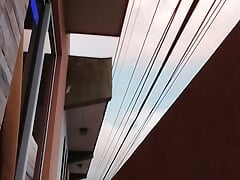 I masturbate on the balcony of my house that overlooks the main street while my neighbor looks out to see what I'm doing.