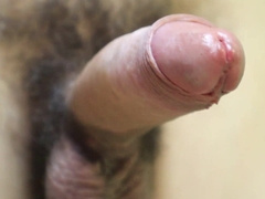 fetish in mittens close-up leaking a plenty of of oil from the crimson head