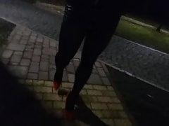 crossdresser walking in public park in heels