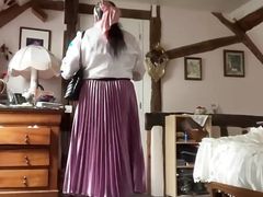 In bourgeoise attire with an old pink pleated skirt for a day
