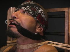 Latino with lots of tattoos is tied up and whipped