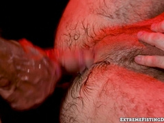 Greg Dixxons fist disappears between the juicy ass cheeks of Feral Fux