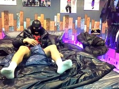 Guy in nylon shorts enjoying handjob on a shiny bed