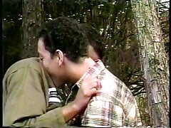 Hairy hunk rides his partner's dick in the woods