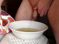 John is peeing into a porcelain bowl