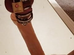 Caged cock taking large dildo in my ass
