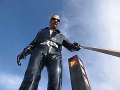 Walking In Strong Wind In Shiny PVC