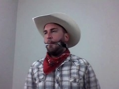 Scruffy guy in wild west setting selfgags with bit gag for gay bondage fun