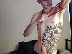 Endo shows off his biceps by pulling on a rubber band for better visibility.