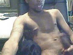 Black dude strokes his cock until he cums on his belly
