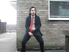 Suited gay jerks off in public