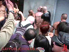 Crowd holds gay down as he endures the cat o' nine tails
