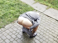 Suited fellow in socks and truss with a fake penis