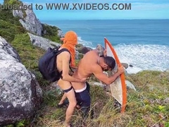 A cheeky surfer getting a prick and urinate from a tourist.