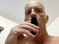 Mature bald guy has fun with butt plug