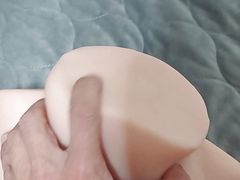 A shaved man inserts a toy into a small pussy